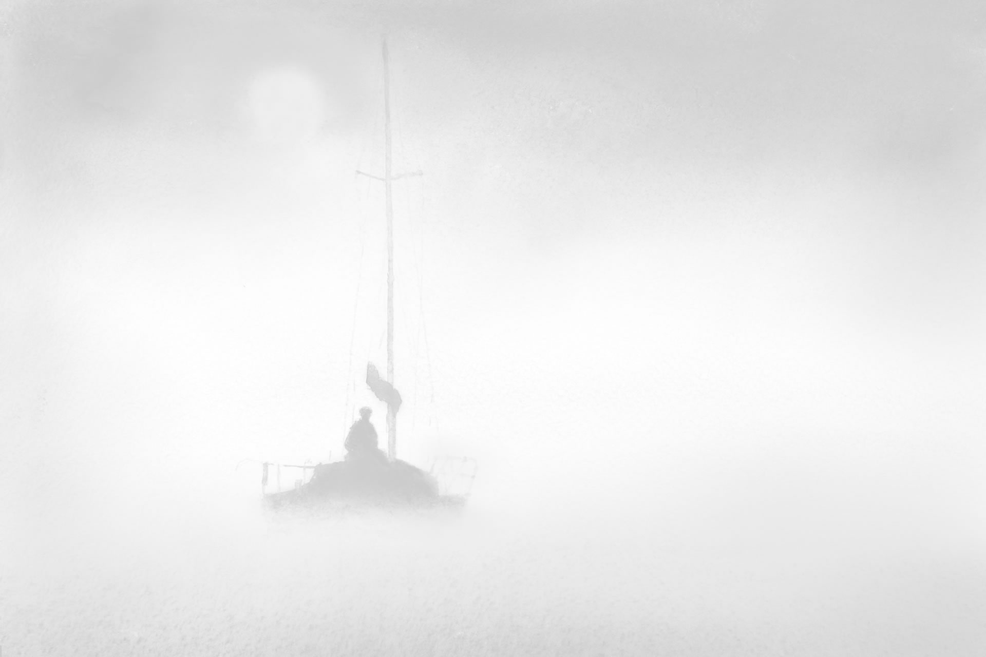 Sailor off shore in the fog
